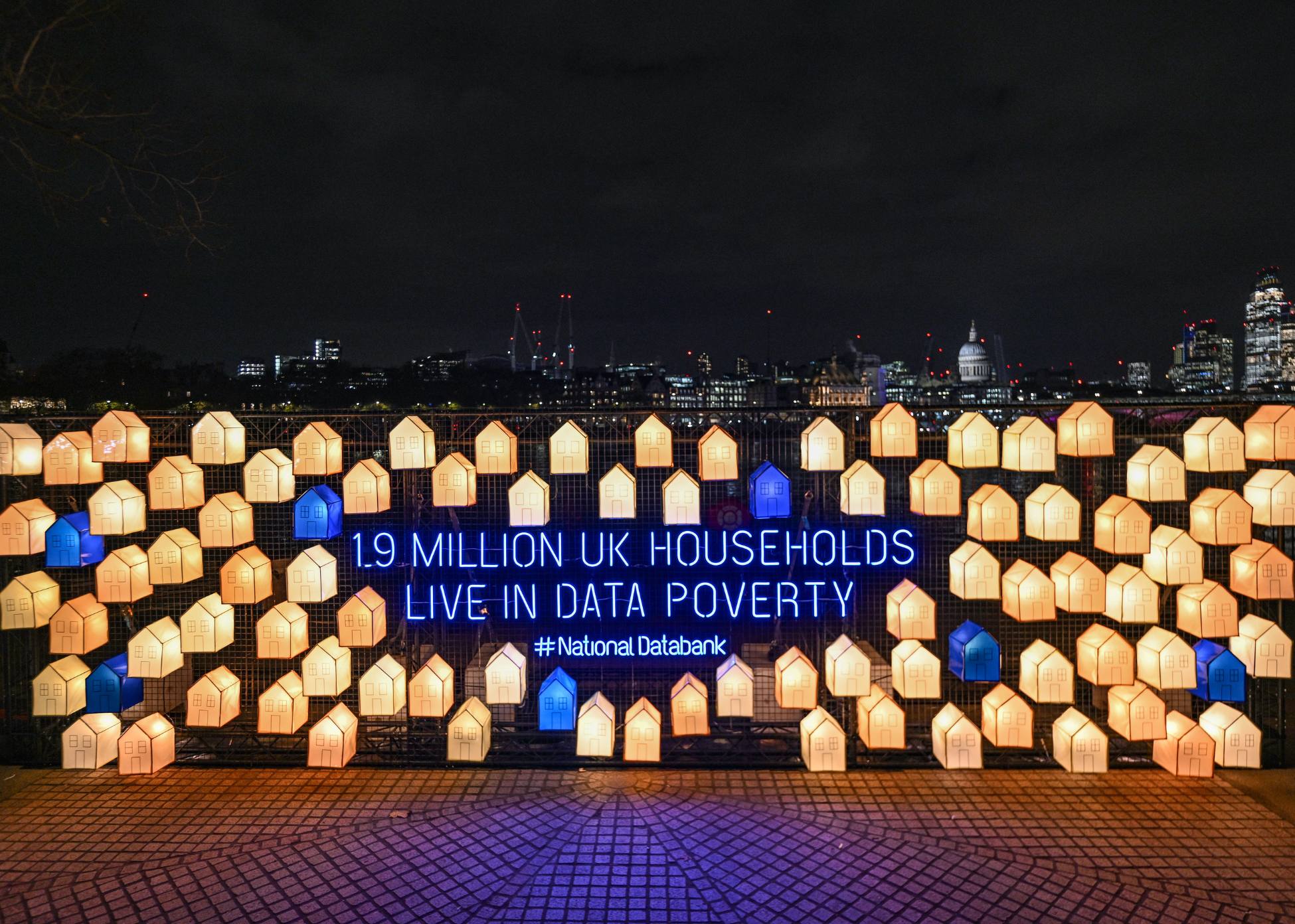 Virgin Media O2 Christmas Installation in Southbank's Observation Point in London. Installation features light up houses, some blue and some yellow. Text in the middle reads "1.9 million UK households live in data poverty. #NationalDatabank"