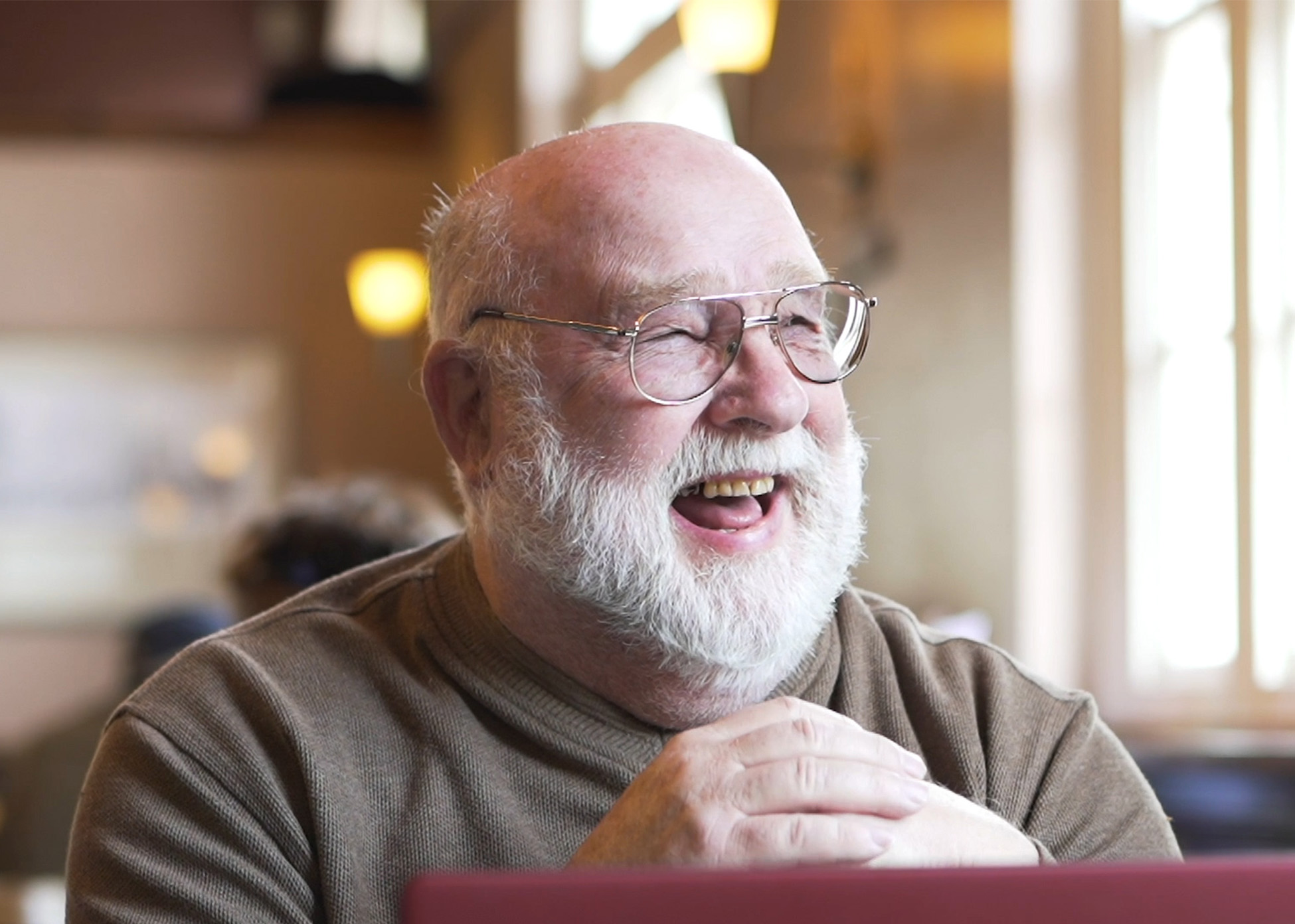 A happy man learning digital skills thanks to the National Digital Inclusion Network